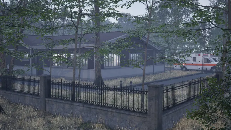 An ambulance parked in the hospital grounds behind iron railings